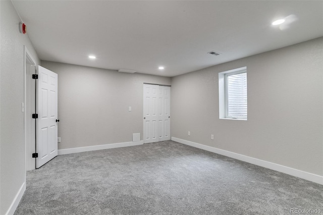below grade area featuring carpet floors, baseboards, visible vents, and recessed lighting