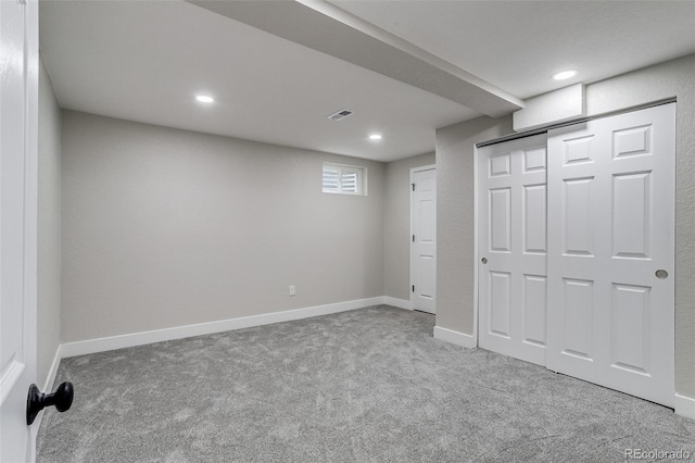 basement featuring carpet floors, visible vents, and recessed lighting
