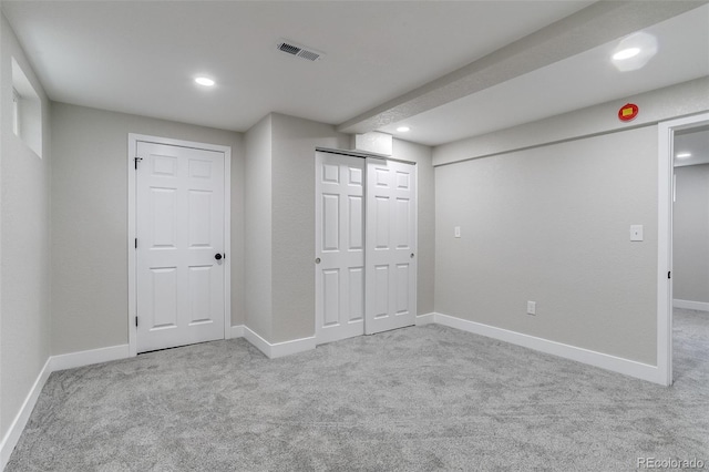 finished basement featuring visible vents, recessed lighting, and carpet