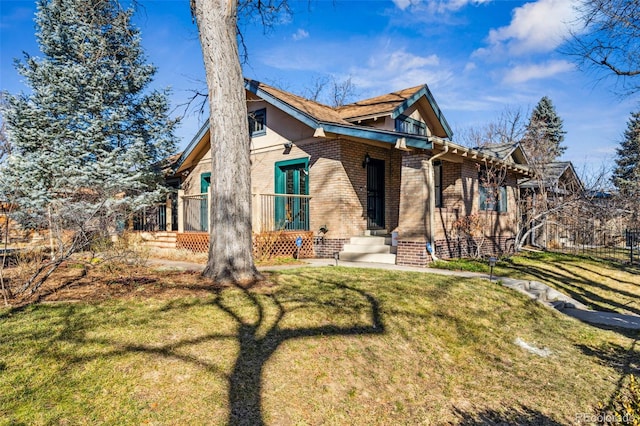 view of front of house featuring brick siding and a front lawn