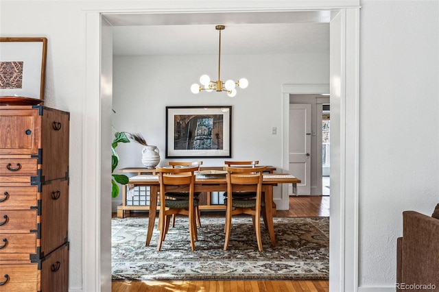 dining room featuring a notable chandelier and wood finished floors