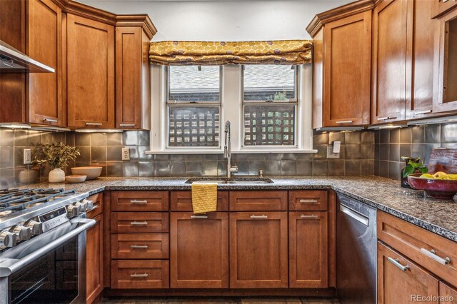 kitchen with brown cabinetry, a sink, ventilation hood, stainless steel appliances, and backsplash