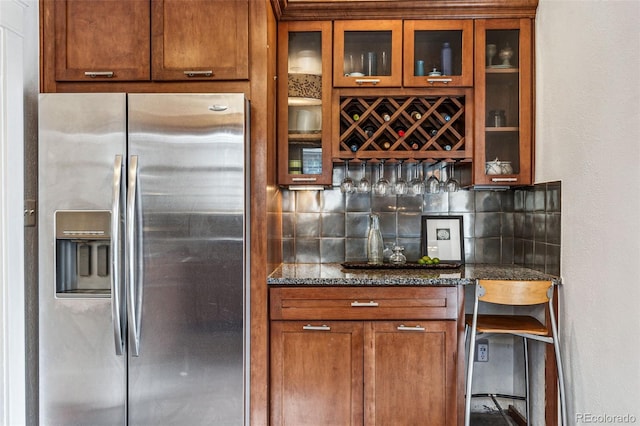 bar featuring a dry bar, stainless steel fridge, and backsplash