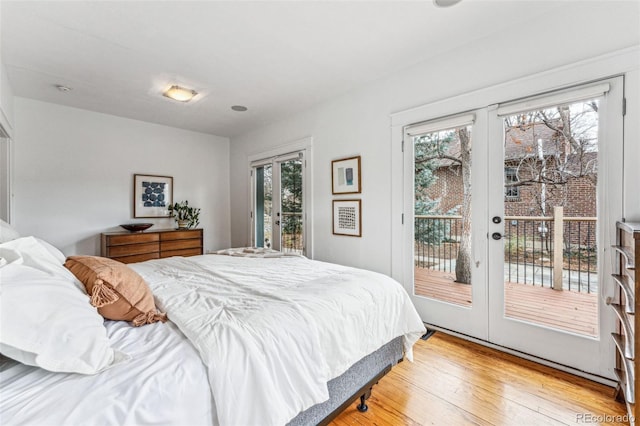 bedroom featuring light wood-type flooring, access to exterior, and french doors