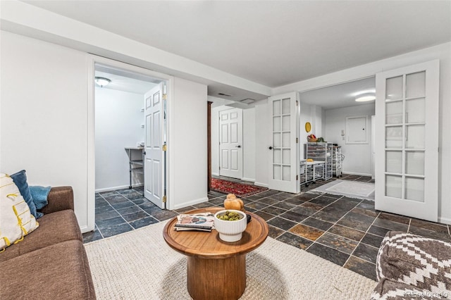 living room with stone tile floors and baseboards