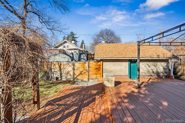 wooden terrace with fence and a gate