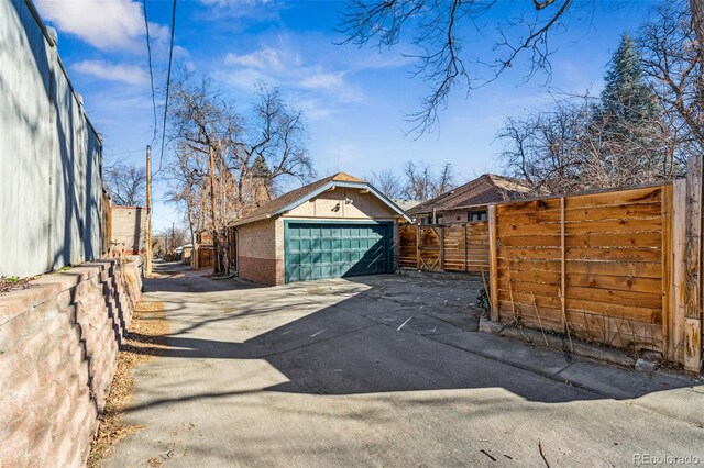 detached garage featuring fence