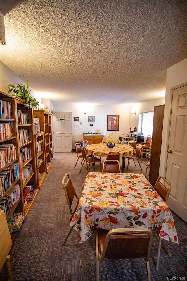 carpeted dining area with a textured ceiling