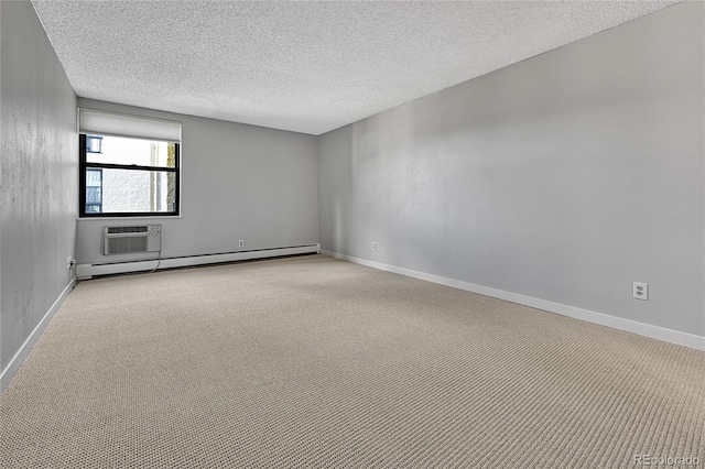 carpeted empty room with a baseboard heating unit, baseboards, a textured ceiling, and an AC wall unit