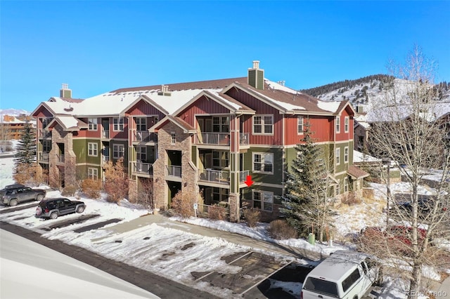 snow covered building featuring a mountain view