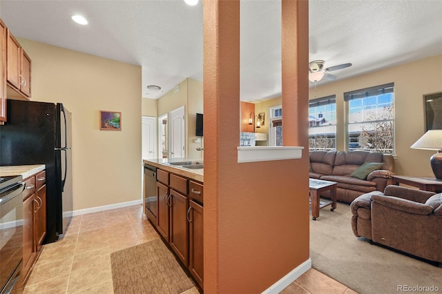 kitchen featuring appliances with stainless steel finishes, a textured ceiling, light tile patterned floors, and ceiling fan