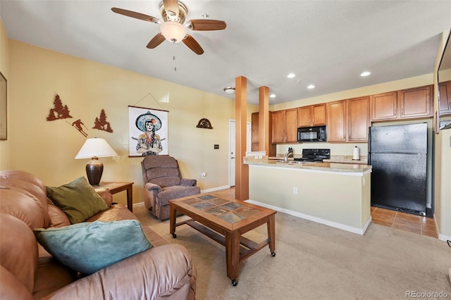 carpeted living room featuring ceiling fan and sink