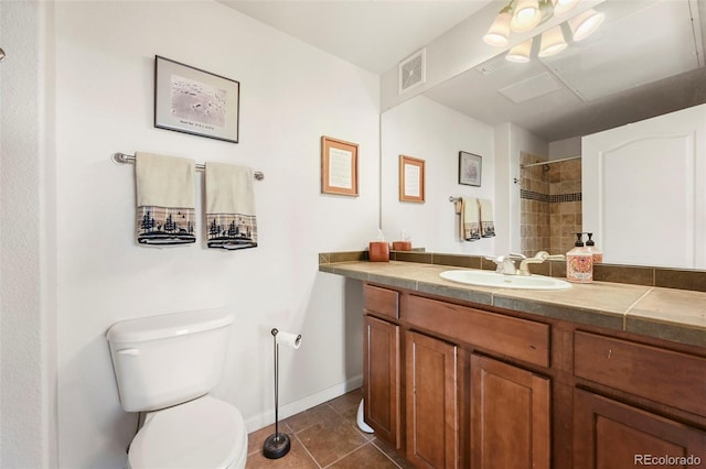 bathroom with tile patterned flooring, vanity, and toilet