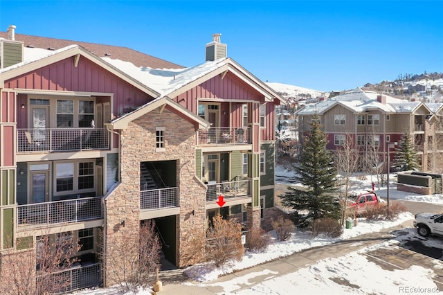 snow covered property featuring central AC unit