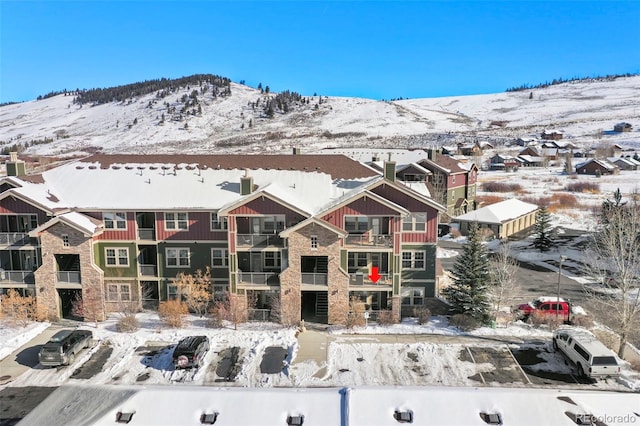 snowy aerial view featuring a mountain view