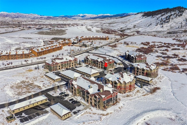 snowy aerial view with a mountain view