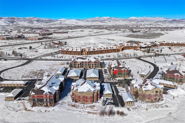 snowy aerial view featuring a mountain view