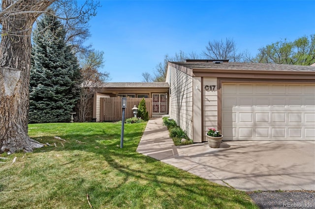 view of front of home featuring a garage, a front lawn, fence, and concrete driveway