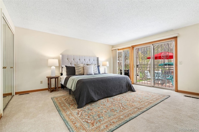 bedroom with carpet flooring, a textured ceiling, access to exterior, baseboards, and visible vents
