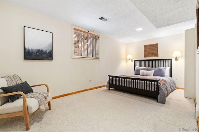 carpeted bedroom with baseboards, a textured ceiling, and visible vents