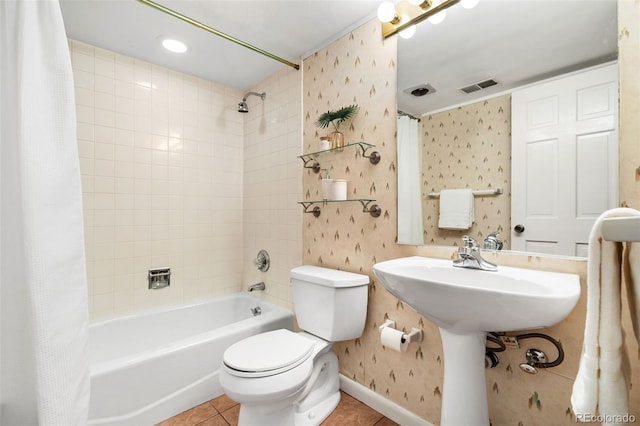 full bath with toilet, tile patterned floors, wallpapered walls, shower / tub combo, and visible vents