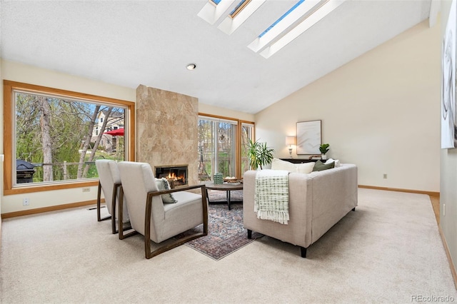 living room with baseboards, carpet, and a tile fireplace
