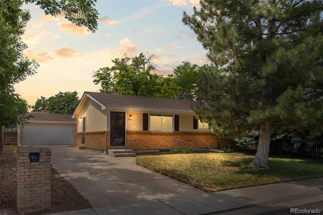 2380 W Baltic Pl, Englewood, CO 80110 - ranch-style home featuring brick siding, a garage, driveway, and a front yard