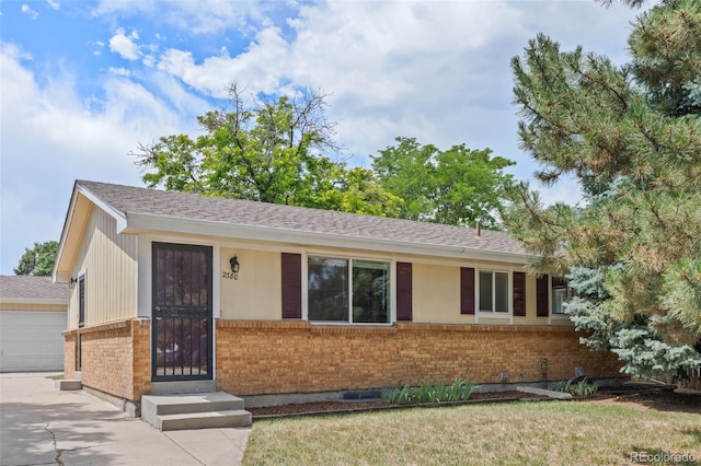 2380 W Baltic Pl, Englewood, CO 80110 - ranch-style home featuring brick siding, a garage, a shingled roof, and concrete driveway