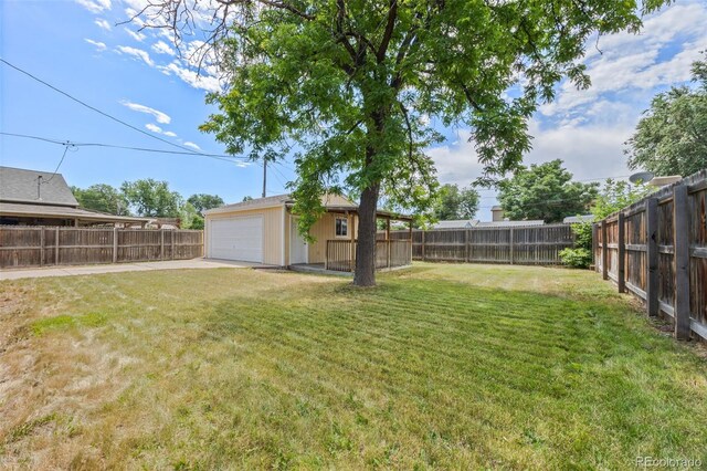 2380 W Baltic Pl, Englewood, CO 80110 - fenced backyard with an outdoor structure, concrete driveway, and a garage