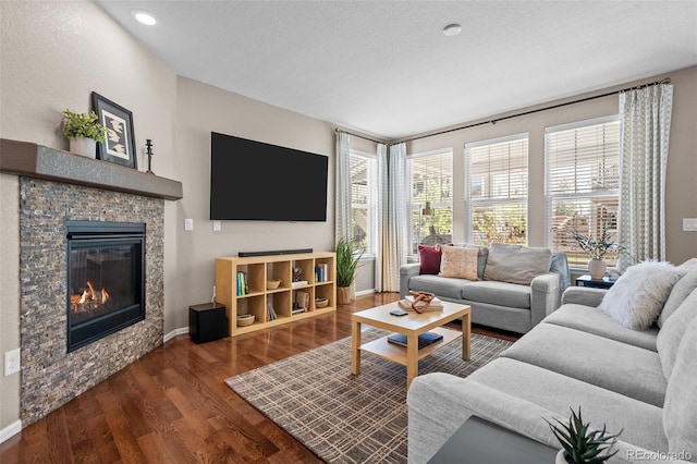 827 Sundance Ln, Erie, CO 80516 - living room featuring a fireplace, wood finished floors, baseboards, and recessed lighting