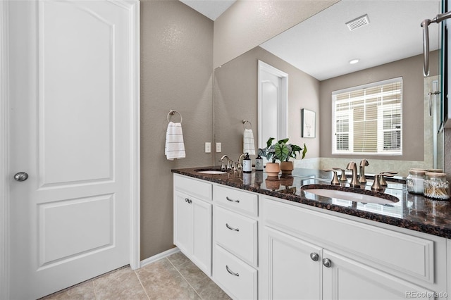 827 Sundance Ln, Erie, CO 80516 - bathroom with double vanity, visible vents, tile patterned flooring, and a sink