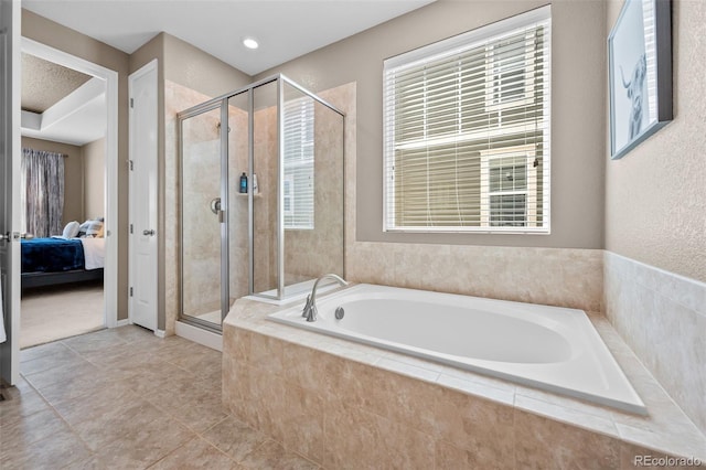 827 Sundance Ln, Erie, CO 80516 - ensuite bathroom with a shower stall, ensuite bath, a garden tub, and tile patterned floors