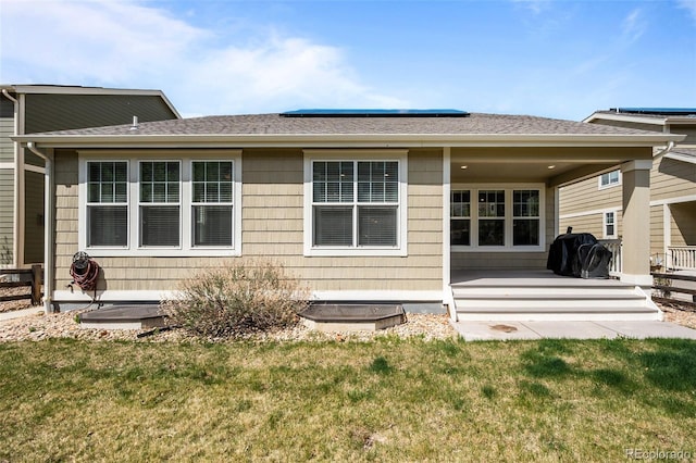 827 Sundance Ln, Erie, CO 80516 - back of property with a lawn and a shingled roof