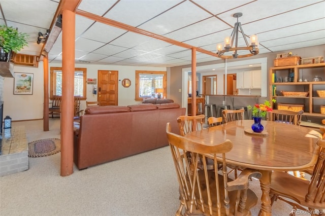 dining area featuring carpet flooring and an inviting chandelier