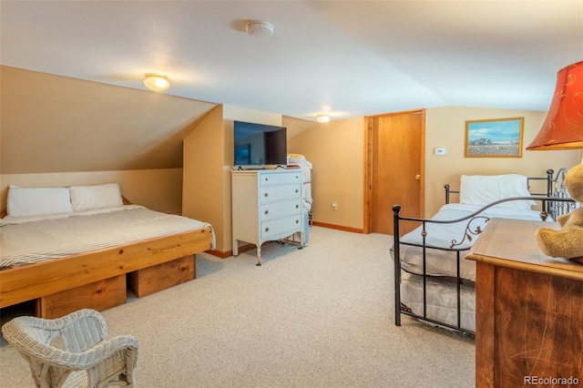 bedroom featuring light colored carpet, vaulted ceiling, and baseboards