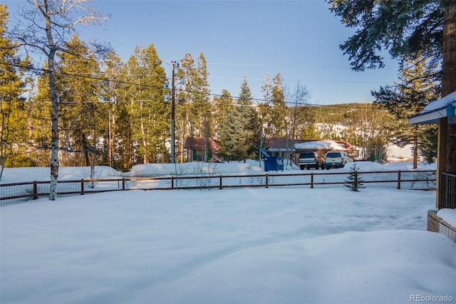 snowy yard with fence