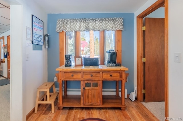 home office with light wood-type flooring and baseboards