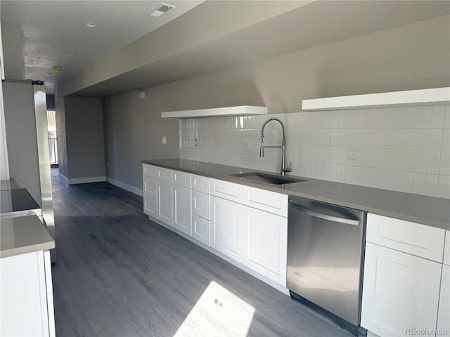 kitchen with dark wood finished floors, tasteful backsplash, visible vents, a sink, and dishwasher