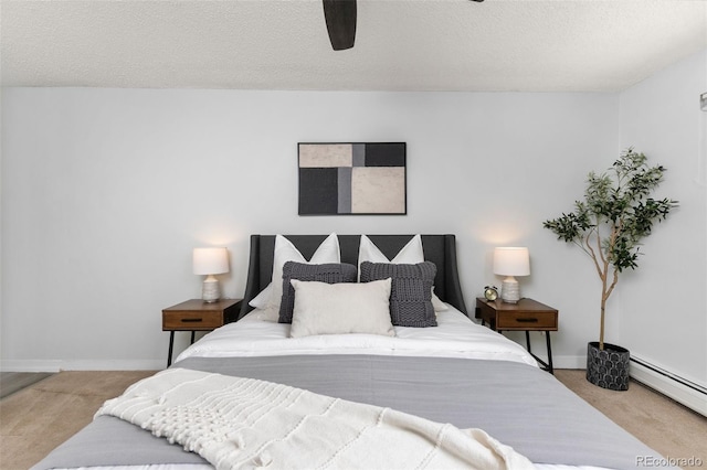 bedroom with carpet floors, a baseboard radiator, and baseboards