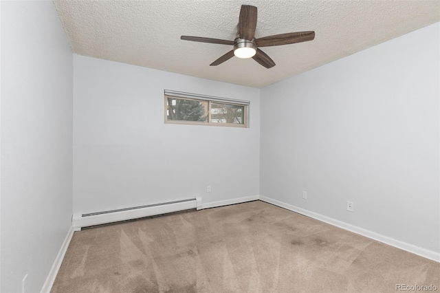 spare room featuring carpet floors, a baseboard radiator, baseboards, and a textured ceiling