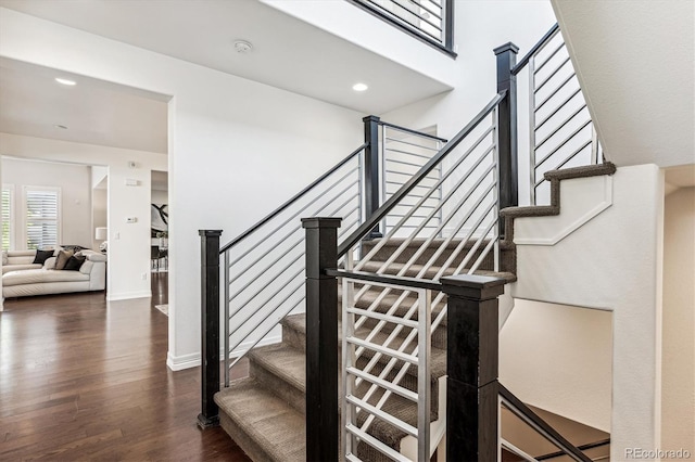 staircase with hardwood / wood-style flooring