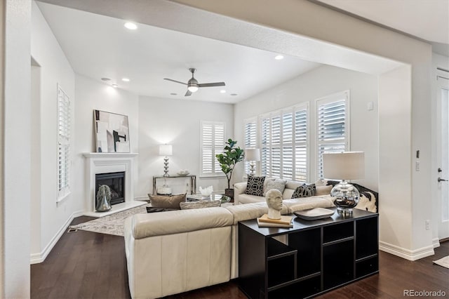 living room featuring ceiling fan and dark hardwood / wood-style flooring