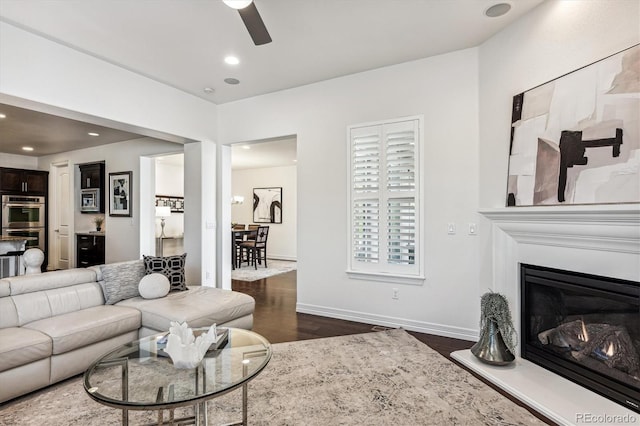 living room with dark hardwood / wood-style floors and ceiling fan