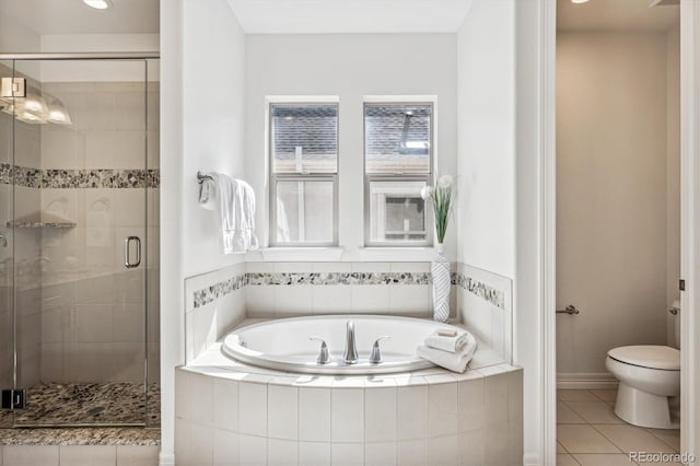 bathroom featuring tile patterned flooring, separate shower and tub, and toilet