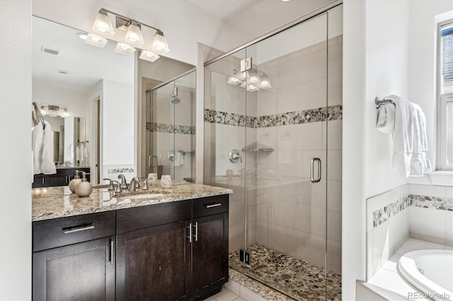 bathroom with tile patterned floors, vanity, and separate shower and tub