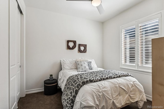 bedroom featuring ceiling fan, a closet, and dark carpet