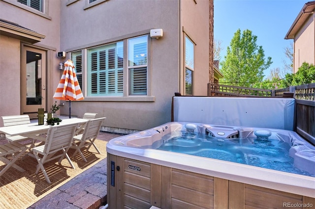 view of patio / terrace with a hot tub