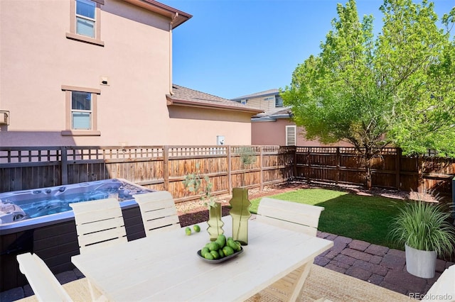 view of patio / terrace with a hot tub