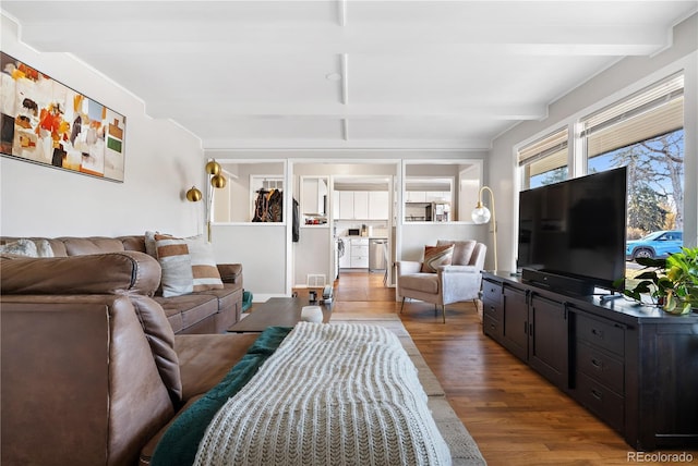 living room featuring wood-type flooring and beam ceiling