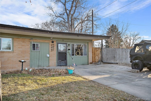 view of front of house with a patio area and a front yard